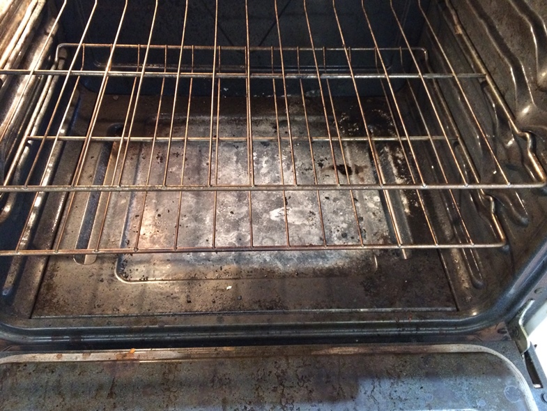  Inside of the oven showing crumbs. 